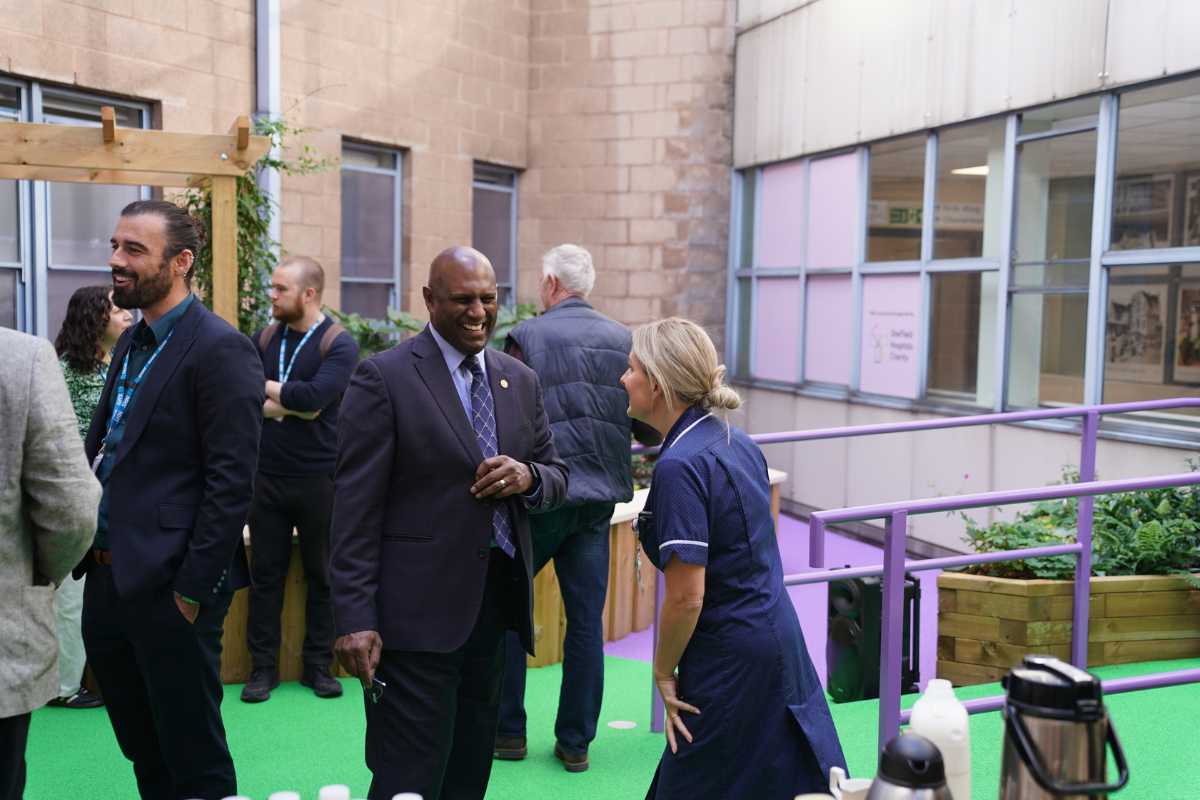 Former Master Cutler Phil Rodrigo with staff in the new garden