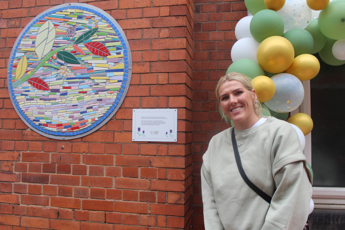 Millie Bright stands by plaque